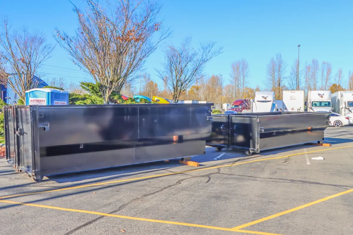 Professional dumpster rental service with roll-off container on residential driveway in East Fishkill